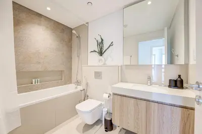 a bathroom with a toilet and a sink and a bath tub at Silkhaus High Floor 1 BDR In The Heart of Downtown in Dubai