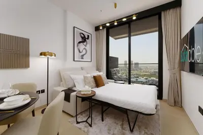 a bedroom with a bed and a table and a dining room at Experience Serenity at Binghatti Crest in JVC in Dubai