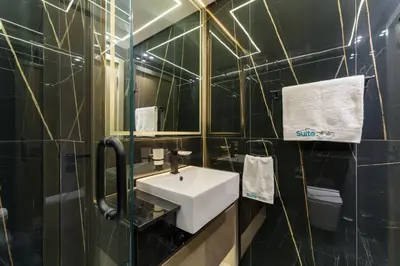 a bathroom with a white sink and a mirror at Experience Serenity at Binghatti Crest in JVC in Dubai