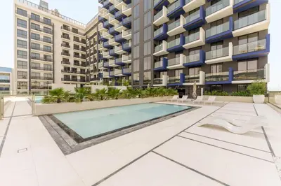 an image of an apartment complex with a swimming pool at Experience Serenity at Binghatti Crest in JVC in Dubai