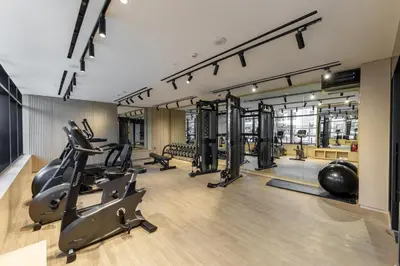 a gym with treadmills ellipticals and exercise equipment at Experience Serenity at Binghatti Crest in JVC in Dubai