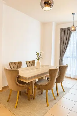 a dining room with a wooden table and chairs at The residences 1 - Luxury 1BR apt in Downtown Dubai - 2 mins walk to Burj Khalifa & Dubai Mall in Dubai