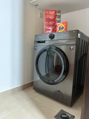 a washing machine is sitting in a room at The residences 1 - Luxury 1BR apt in Downtown Dubai - 2 mins walk to Burj Khalifa & Dubai Mall in Dubai