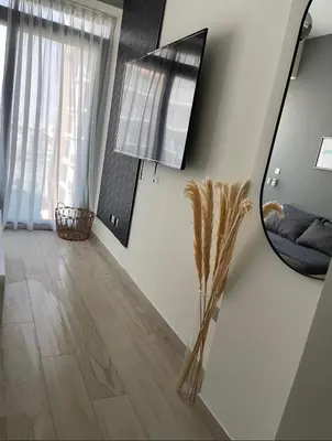 a mirror on the wall of a living room at Chic apartment, Maydan Riviera Dubaï in Dubai