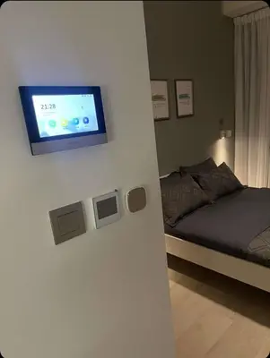 a room with a bed and a tv on a wall at Chic apartment, Maydan Riviera Dubaï in Dubai