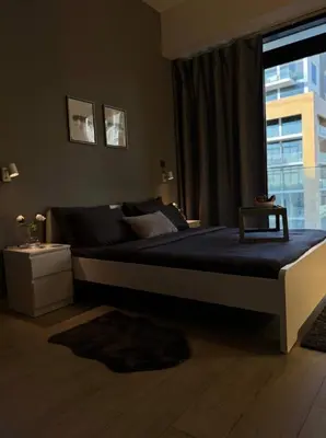 a large bed in a bedroom with a window at Chic apartment, Maydan Riviera Dubaï in Dubai