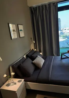 a bedroom with a bed with a window at Chic apartment, Maydan Riviera Dubaï in Dubai