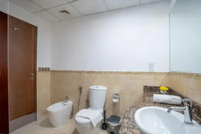 a bathroom with a toilet and a sink at RH- Walk to JBR beach & Tram, Comfortable 02BR in Dubai