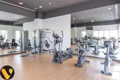 a gym with several treadmills and exercise bikes at Vogue Creek Harbour Breeze Creek Beach Waterfront Living Close to Downtown, Burj Khalifa and Dubai Mall, Two Bedroom apartment With Balcony and Private Manmade Beach, Access to all Amenities in Dubai