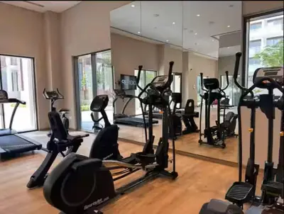 a gym with a lot of exercise bikes and a mirror at Vogue Creek Harbour Breeze Creek Beach Waterfront Living Close to Downtown, Burj Khalifa and Dubai Mall, Two Bedroom apartment With Balcony and Private Manmade Beach, Access to all Amenities in Dubai