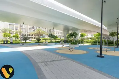an empty parking lot with a building in the background at Vogue Creek Harbour Breeze Creek Beach Waterfront Living Close to Downtown, Burj Khalifa and Dubai Mall, Two Bedroom apartment With Balcony and Private Manmade Beach, Access to all Amenities in Dubai