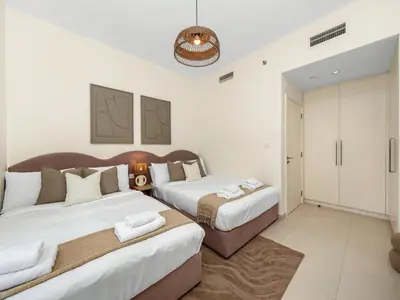 a bedroom with two beds in a room at Sky High 2-Bedroom Apartment Stunning Opera & Downtown Views Opp Dubai Mall in Dubai