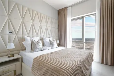 a bedroom with a large bed with a large window at Vida Voyage - Vida Residences - Creek Harbour in Dubai