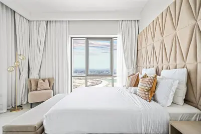 a bedroom with a large bed with a large window at Vida Voyage - Vida Residences - Creek Harbour in Dubai