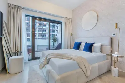 a bedroom with a large bed and a large window at Lux-Furnished Stu Couple-Friendly Near Downtown in Dubai