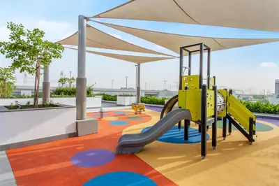 a playground with a slide and a play structure at Lux-Furnished Stu Couple-Friendly Near Downtown in Dubai