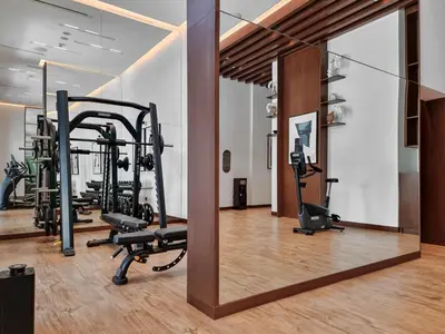 a gym with treadmills and ellipticals in a room at Harbour Oasis - Vida Residences - Creek Harbour in Dubai