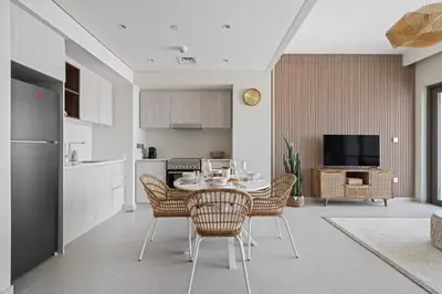 a kitchen and dining room with a table and chairs at Harbour Oasis - Vida Residences - Creek Harbour in Dubai