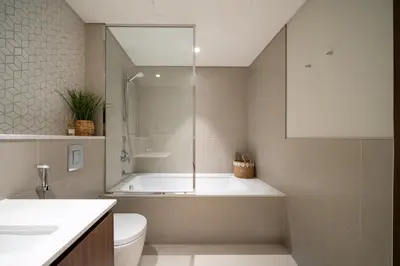 a bathroom with a tub and a toilet and a sink at Harbour Oasis - Vida Residences - Creek Harbour in Dubai
