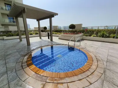 a swimming pool in the middle of a patio at 1 Bed room - Azizi Daisy - Furjan in Dubai