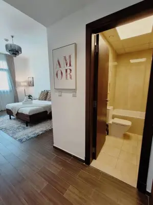 a room with a bedroom with a bed and a bathroom at 1 Bed room - Azizi Daisy - Furjan in Dubai