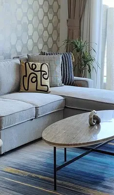 a living room with a couch and a coffee table at 1 Bed room - Azizi Daisy - Furjan in Dubai