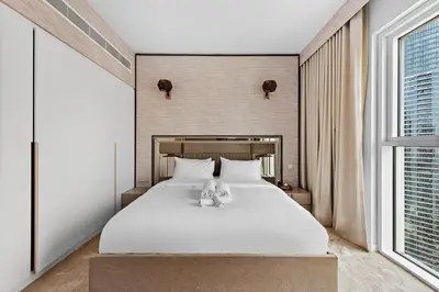 a bedroom with a bed with a stuffed animal on it at La Vie, JBR, Dubai in Dubai