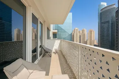 a balcony with a chair and a view of the city at La Vie, JBR, Dubai in Dubai