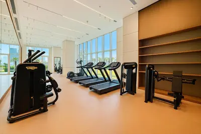 a gym with a row of treadmills and ellipticals at La Vie, JBR, Dubai in Dubai