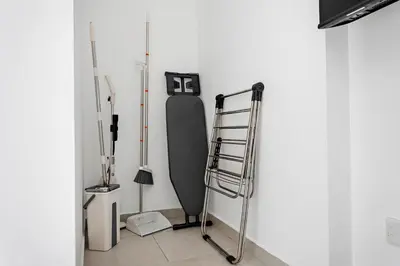 a surfboard leaning against a wall next to a ladder at Stonetree - Goldcrest Views 2 - Prime Location in Dubai