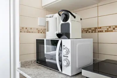 a microwave oven sitting on top of a kitchen counter at Stonetree - Goldcrest Views 2 - Prime Location in Dubai
