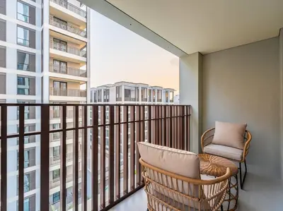 a balcony with a chair and a large window at Ravishing Retreat 2BR Creek Beach Luxury Abode in Dubai