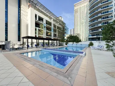 a swimming pool in the middle of a building at Trophy - Magical Marina 1BDR connected to Metro Station in Dubai