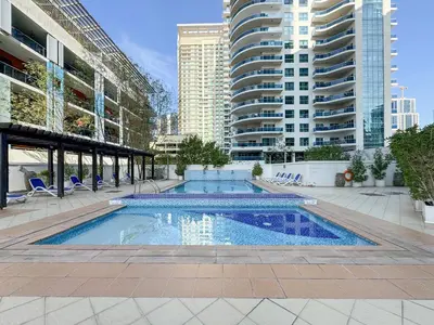a swimming pool in a city with tall buildings at Trophy - Magical Marina 1BDR connected to Metro Station in Dubai
