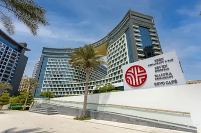 a sign in front of a building at Chic Palm Studio with Infinity Pool in Dubai