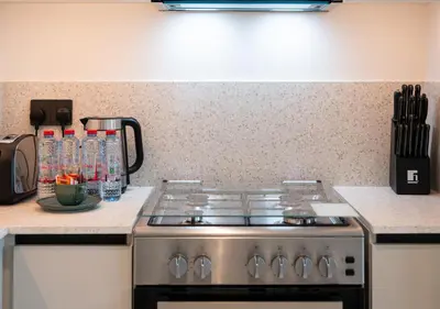 a stove top oven in a kitchen next to a counter at Waterfront ,High Floor 2BED with Private Beach Access in Dubai