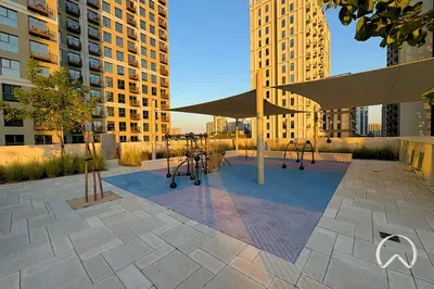 a playground in a city with tall buildings at Oraya - Collective 2 0 Tower A Sanctuary in Dubai Hills in Dubai