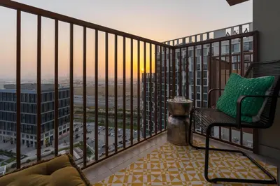 a balcony with a chair and a view of the city at Oraya - Collective 2 0 Tower A Sanctuary in Dubai Hills in Dubai