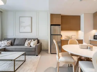 a living room with a couch and a table at Serenity Cove: 1BR Luxury Beach Retreat in Dubai