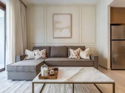 a living room with a couch and a coffee table at Serenity Cove: 1BR Luxury Beach Retreat in Dubai