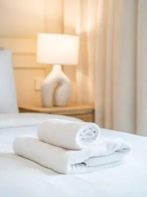 a pile of towels sitting on top of a bed at Serenity Cove: 1BR Luxury Beach Retreat in Dubai