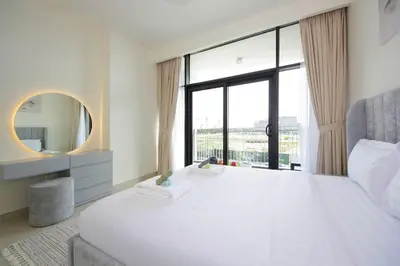 a bedroom with a large white bed and a mirror at Park Point C-1 bedroom for monthly stay-1003 in Dubai