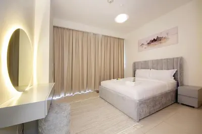 a bedroom with a large bed and a mirror at Park Point C-1 bedroom for monthly stay-1003 in Dubai
