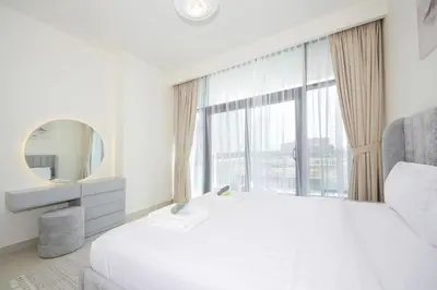 a white bedroom with a large window and a bed at Park Point C-1 bedroom for monthly stay-1003 in Dubai