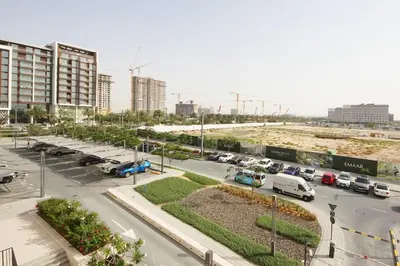 a parking lot with cars parked in a city at Park Point C-1 bedroom for monthly stay-1003 in Dubai