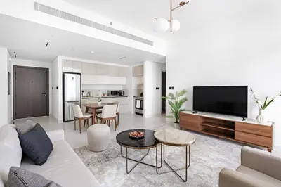 a living room with a couch and a tv at Silkhaus Sea & Palm View 1BDR in Marina Vista in Dubai