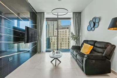 a living room with a couch and a large window at Luxury 1BR Apartment in Dubai Marina Gate in Dubai