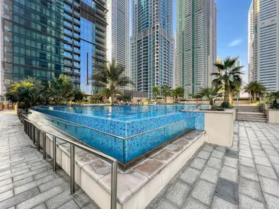 a swimming pool in a city with tall buildings at Luxury 1BR Apartment in Dubai Marina Gate in Dubai