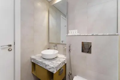 a bathroom with a sink and a mirror at Aykon Luxury Sky Collection Suites with Balcony & Sea View by HSHOME in Dubai