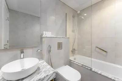 a bathroom with a sink and a toilet and a shower at Aykon Luxury Sky Collection Suites with Balcony & Sea View by HSHOME in Dubai